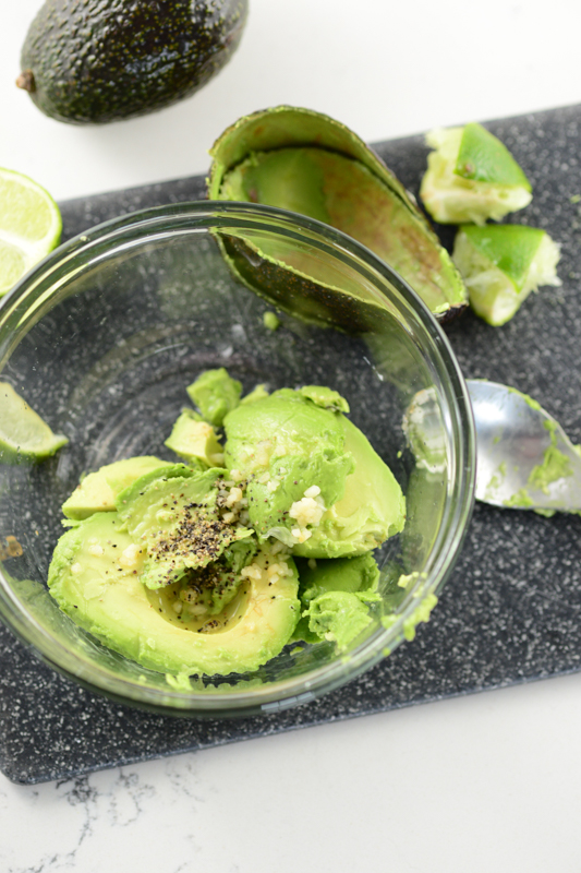 avocado being mashed for guacamole