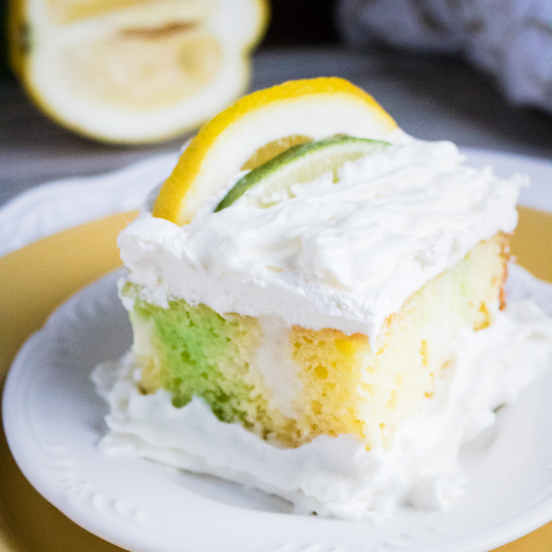 lime lemon poke cake on a serving plate.