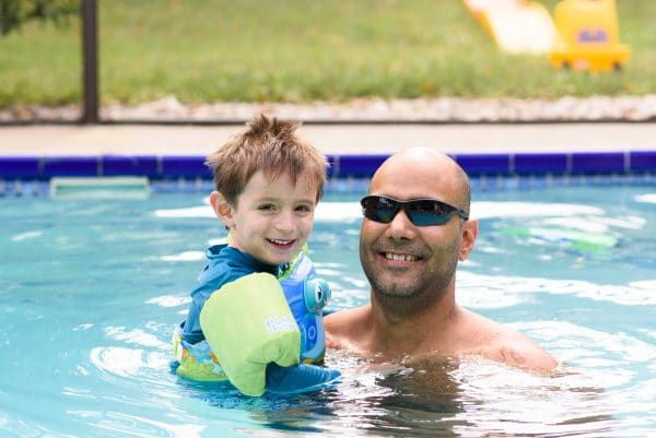 dad and son swimming in the pool