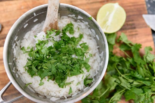 stirring cilantro into rice