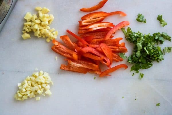 veggies being sliced for thai peanut noodle recipe