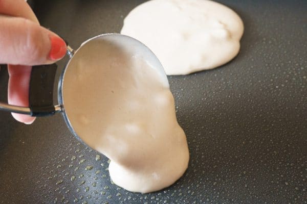 pouring chai spiced pancake batter onto griddle