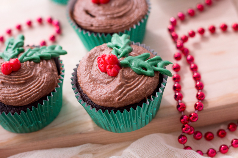 christmas cupcakes decorated with holly leaves