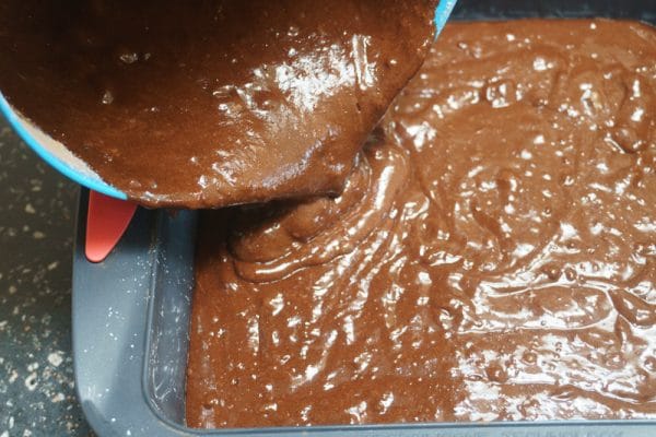 pouring batter into the brownie pan