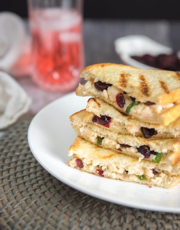 cranberry grilled cheese being served on a white plate