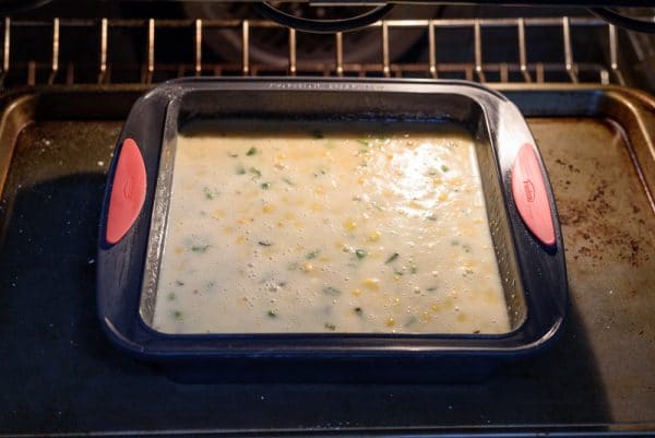 placing the spicy cornbread in the oven to bake