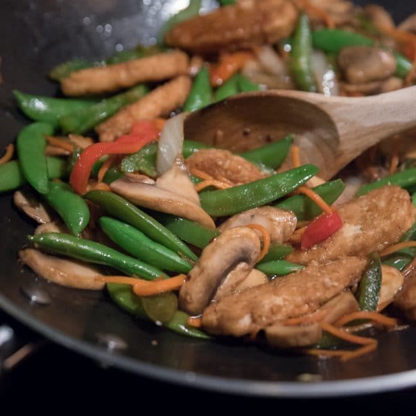 cooking the vegan stir fry in a wok