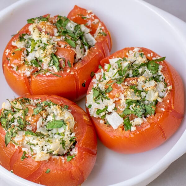 baked stuffed tomatoes on a white plate