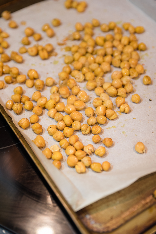 roasted chickpeas on a baking sheet with parchment paper