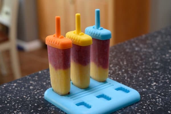 popsicle molds filled with strawberry and mango