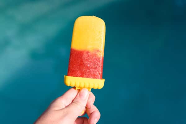 fruit popsicle with layers or strawberry and mango