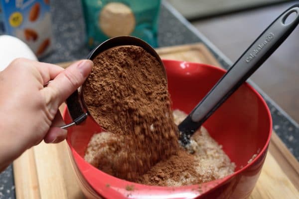 adding cocoa to the flourless chocolate cake batter