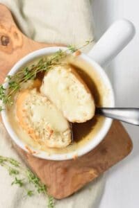 Tender onions are simmered in a savory broth, topped with cheesy toast