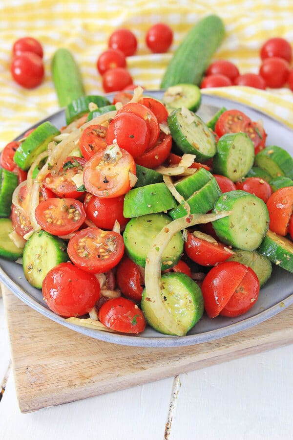 cucumber tomato salad on a yellow tablecloth