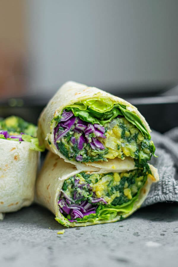 vegan breakfast burritos stacked on a plate