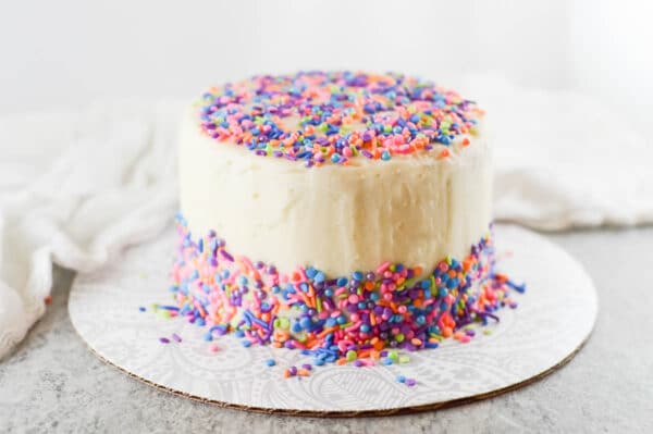 vegan birthday cake covered in vegan buttercream frosting
