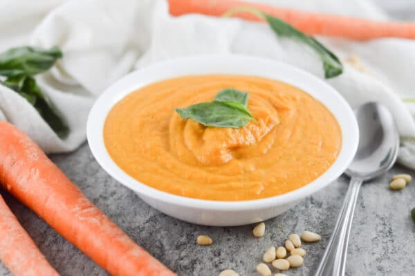 vegan carrot soup topped with fresh herbs