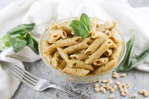vegan pesto pasta being served on a table