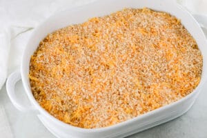 putting vegan mac and cheese into a baking dish