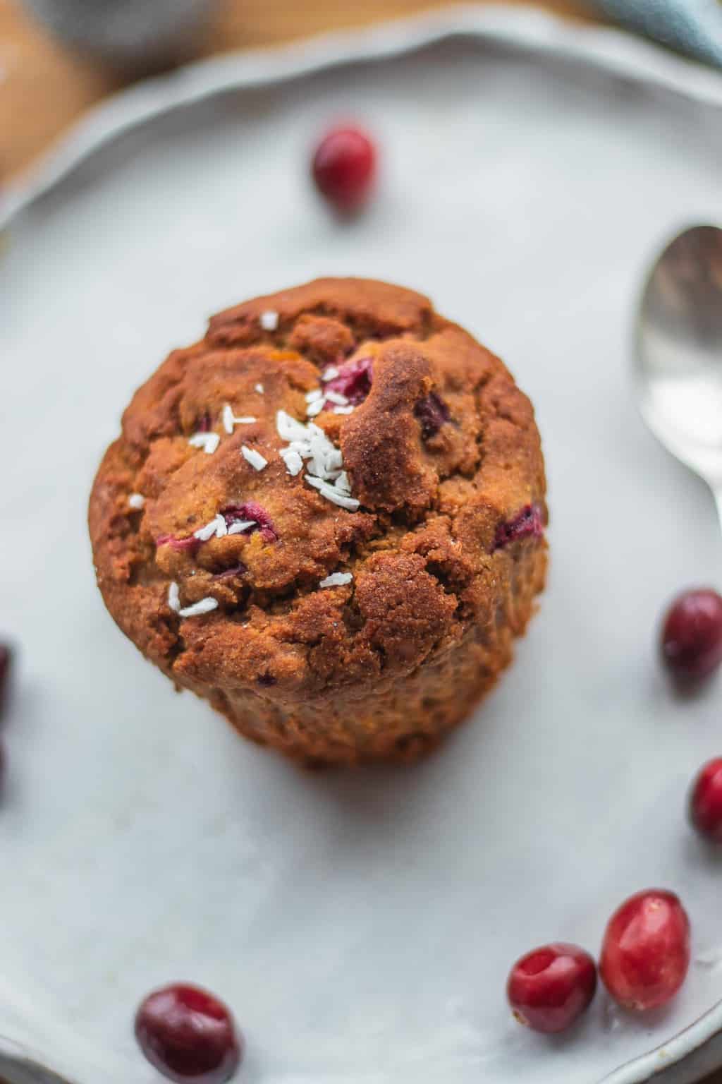 closeup of muffin with cranberries on top