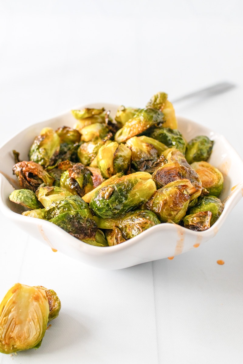 side view bowl of honey sriracha brussels sprouts