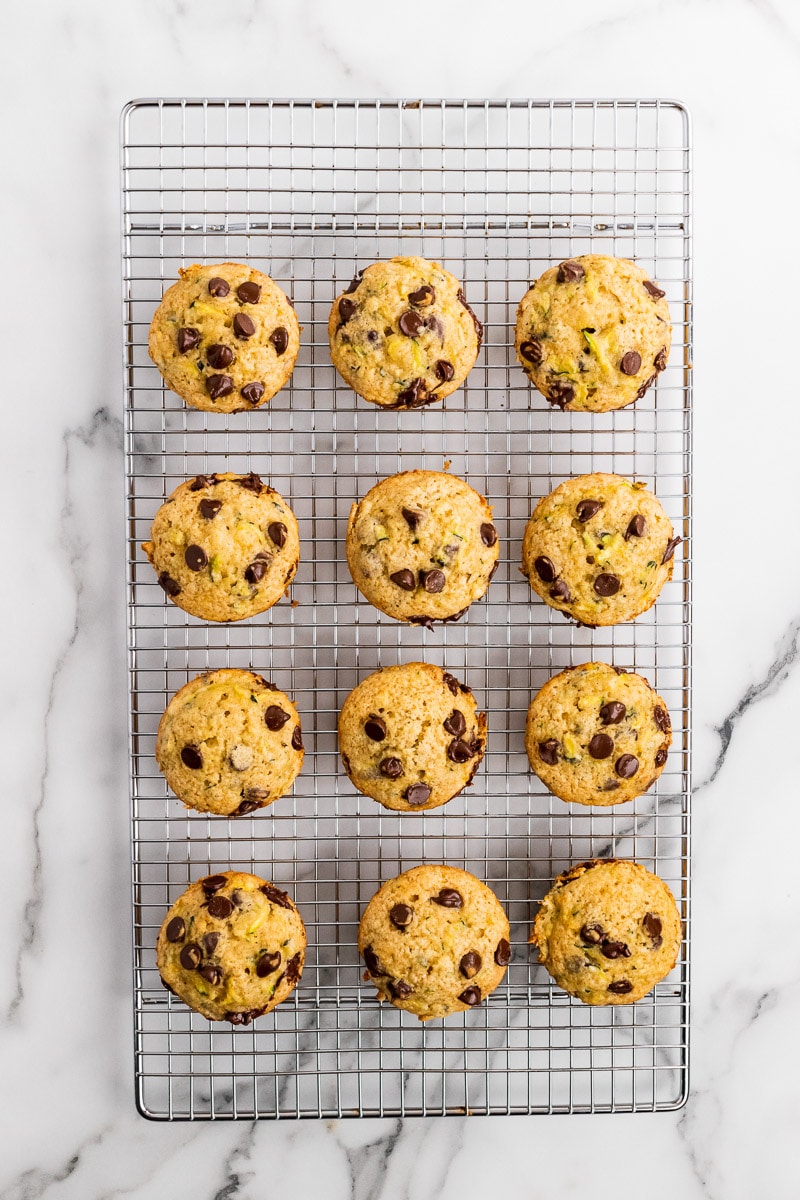 zucchini chocolate chip muffins on a cooling rack