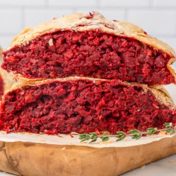 slices of vegan beet wellington stacked on a cutting board