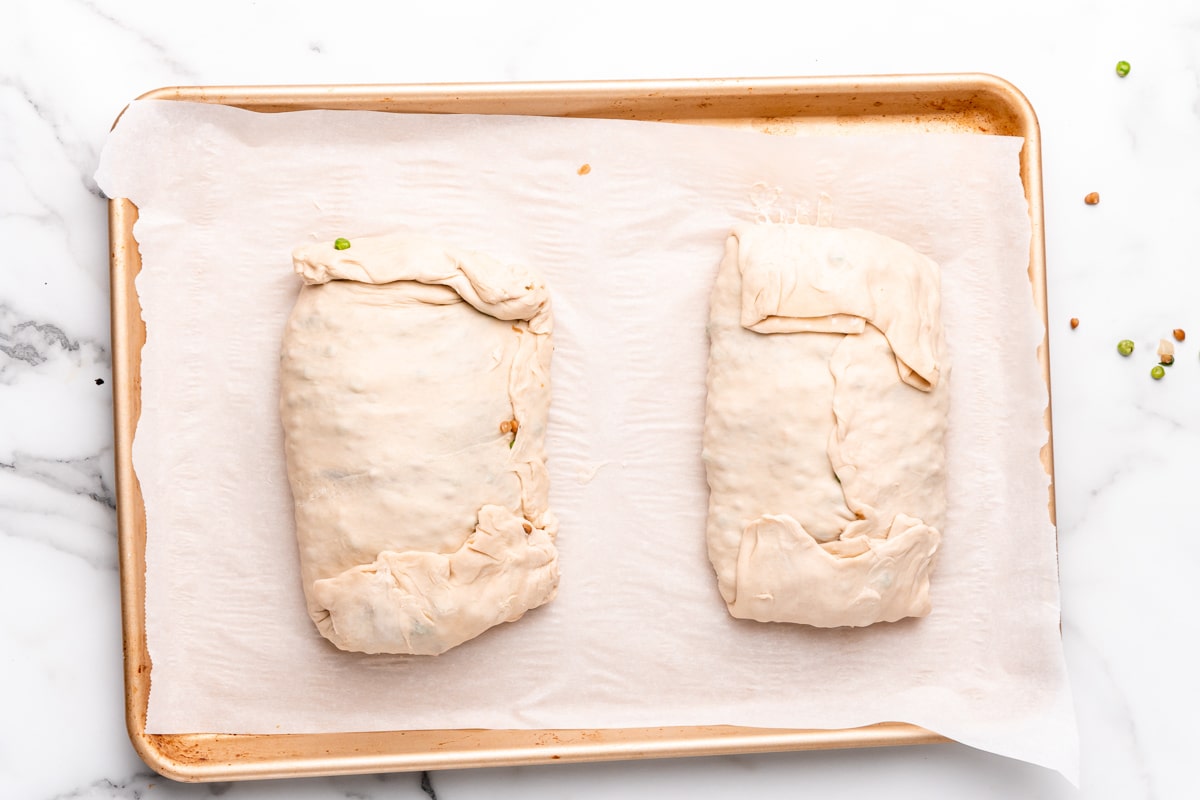 rolling up the puff pastry around the vegan wellingtons