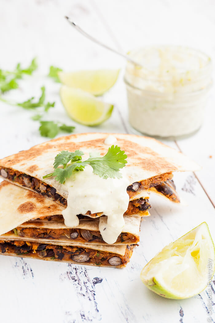 Vegan Sweet Potato Quesadilla Recipe - With black beans, smoked paprika and coriander and ground cumin, these vegan sweet potato quesadillas are hearty and packed full of flavour. Serve with a generous dollop of lime cashew cream and an extra squeeze of lime along with a side salad for a delicious weeknight dinner. | Click to get the recipe